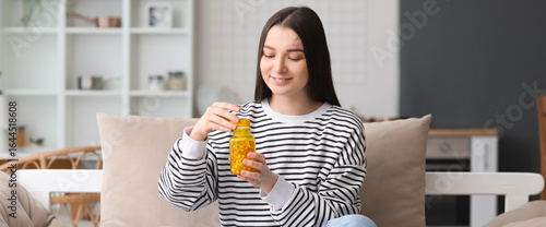 Young woman with bottle of ...