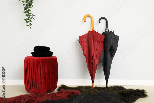 Hat on stylish pouf and umb...