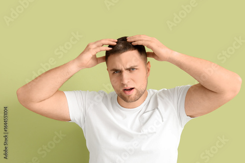 Worried young man with hair...