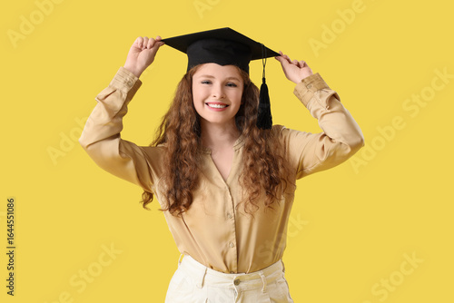 Happy female student in gra...