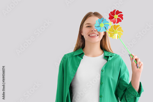 Young woman with toy windmi...