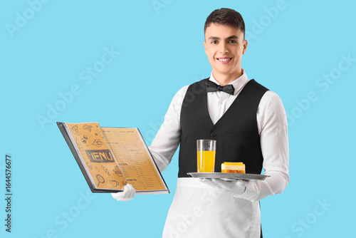 Young male waiter holding t...
