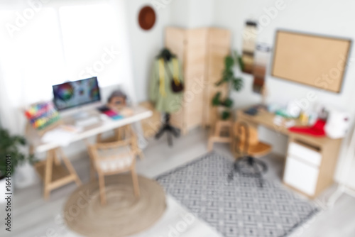 Wallpaper Mural Blurred view of atelier with desks, clothes and mannequin Torontodigital.ca