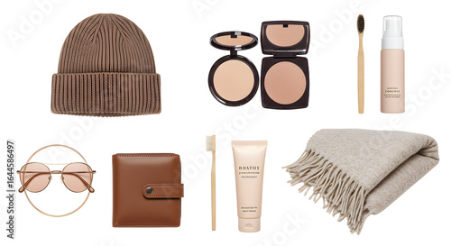 LIFESTYLE - Flat lay of brown winter accessories and beige makeup items including beanie, sunglasses, wallet, compact powder, brush, foundation, cream tube, and fringed scarf on white background
