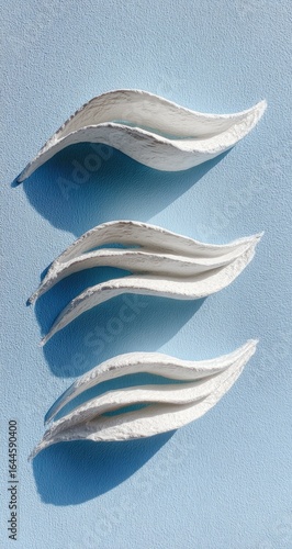 White paper art, wave design, blue background, studio shot, craft project