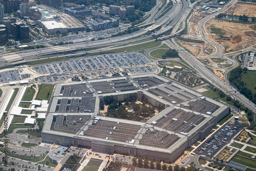 Aerial view of the Pentagon complex with surrounding roads, parking and greenery. g.