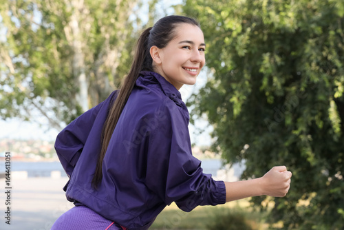 Sporty young woman running ...