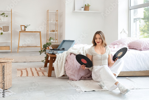 Young woman with vinyl disk...