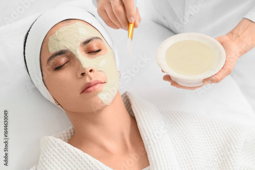 Beautician applying mask on...