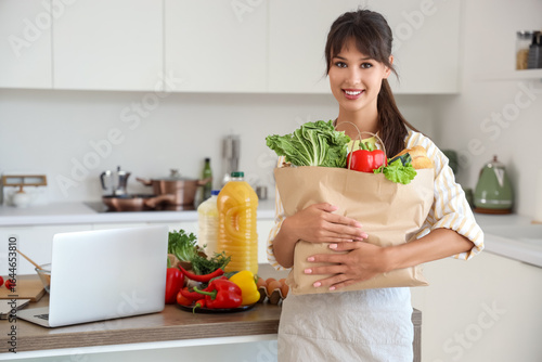 Young woman with paper bag ...