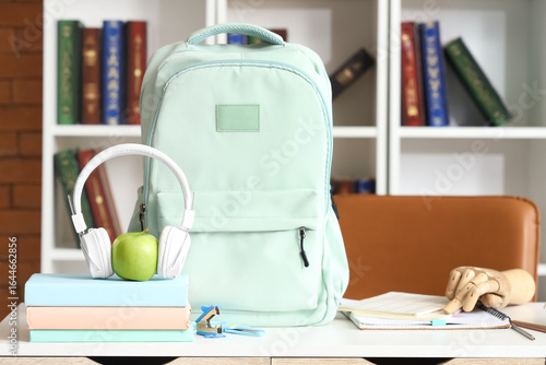 Headphones with apple, book...