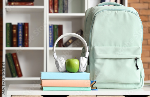 Headphones with apple, book...