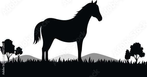 A majestic black horse silhouette standing peacefully on a grassy hill, portraying elegance and strength in a serene outdoor landscape.