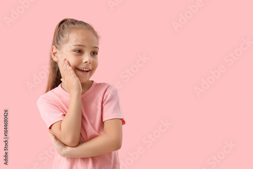Happy little girl on pink b...