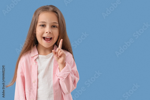 Cute little girl pointing a...