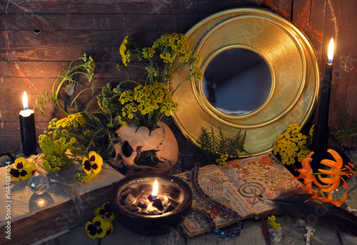 Wallpaper Mural Mystic still life with skull, mirror, decorated magic book of spells, tansy flowers, black candles and witchy ritual objects.  No foreign language, only fantasy symbols Torontodigital.ca