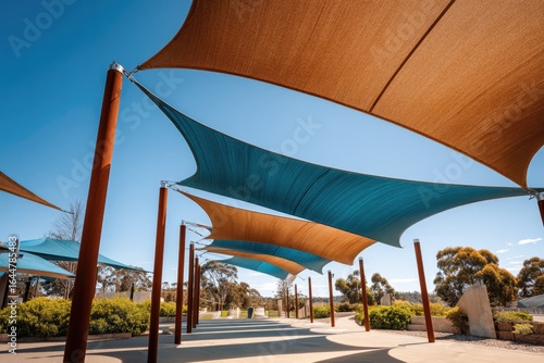 Sun-drenched walkway with modern, angled shade sails
