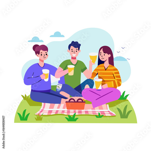 Three happy friends enjoying a summer picnic together outdoors on a checkered blanket with drinks and a picnic basket full of food