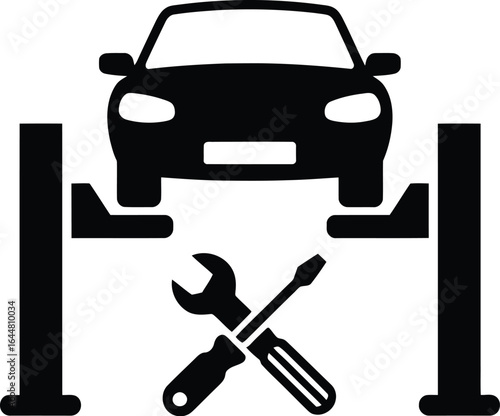 Silhouette of a car being serviced on a hydraulic lift with tools