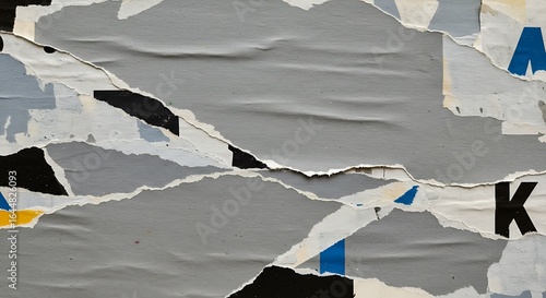 Abstract background of torn and peeled paper posters, revealing layers of texture and fragmented typography, creating a distressed urban wall art effect.