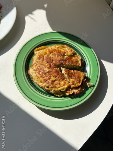 Fluffy telur dadar (omelet) with golden edges and a soft center, often mixed with vegetables or seasonings—offering a perfect blend of savory flavor and comforting simplicity in every bite.