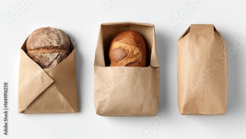Three loaves of bread in brown paper bags