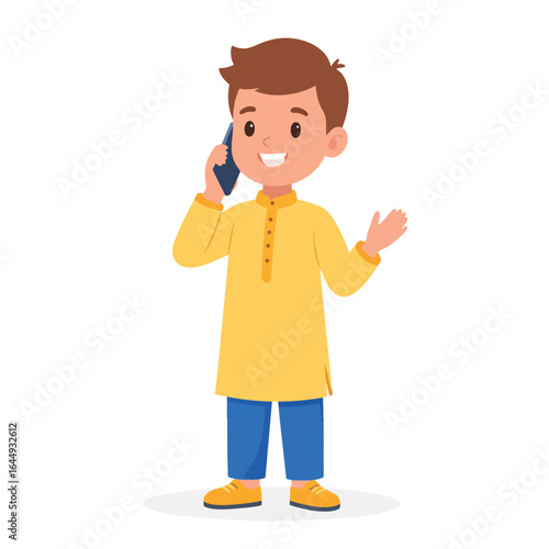A young boy in a yellow kurta talking on a smartphone, gesturing with his hand.