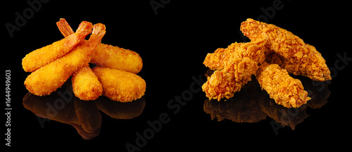 Crispy fried shrimp and chicken tenders served on a black background