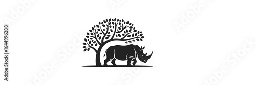 Silhouette of a rhino under a tree showcasing nature and wildlife harmony in black and white art