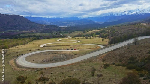 Aerial footage of the vehicles driving on the Carretera Austral curves sharply in Patagonia, Chile