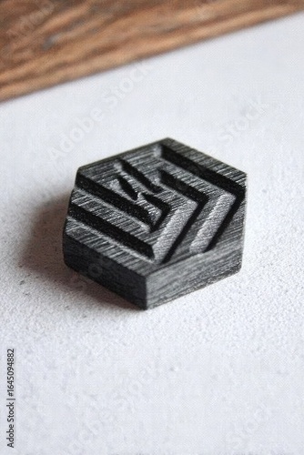 Dark gray hexagonal wooden trinket with carved design