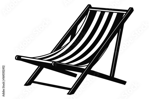 Black and white striped beach chair invites relaxation on a sunny summer day