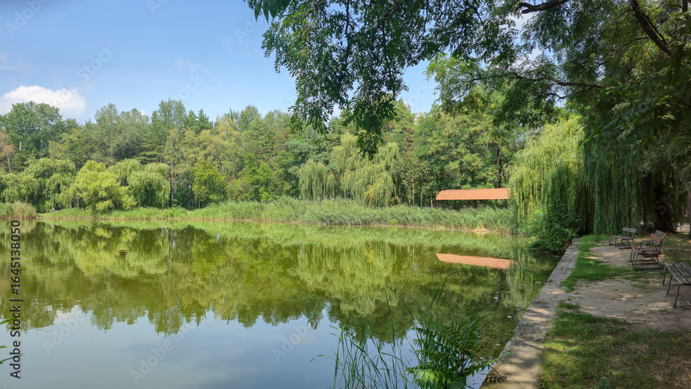 Summer river landscape with green trees, reflections and blue sky. Tourism Summer river landscape with green trees, reflections and blue sky. Tourism