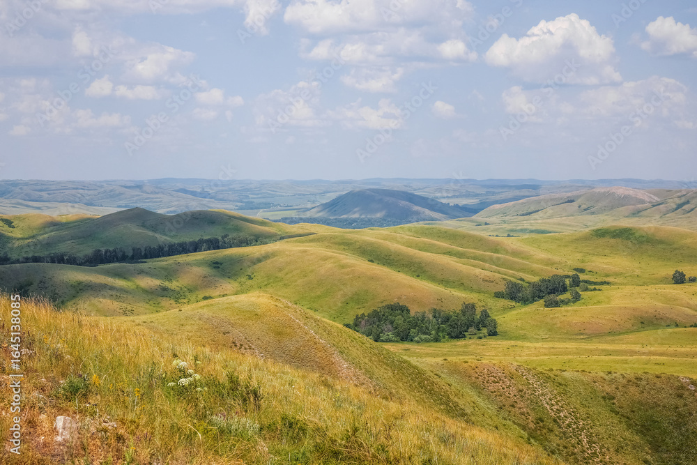 Fototapeta premium Rolling green grassland hills.