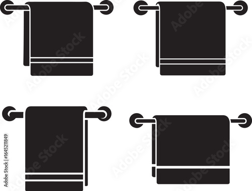 Four towels hanging on towel racks silhouette