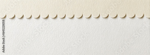 Cream and white textured paper with scalloped edge