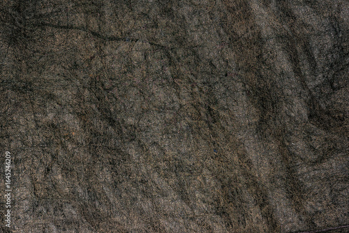 Old black plastic canvas with a rough surface