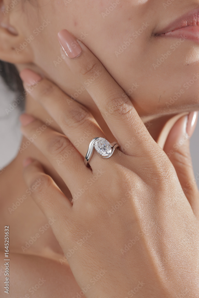 Elegant silver engagement ring with a large round-cut diamond, beautifully displayed on a woman’s hand. Elegant silver engagement ring with a large round-cut diamond, beautifully displayed on a woman’s hand.