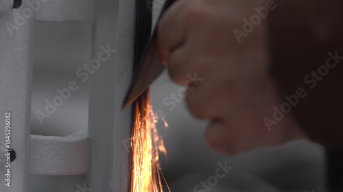 Detail of a master sharpening a steel knife