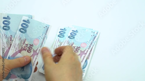 Turkish money 100 TL, female hand when calculating