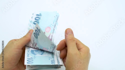 Turkish money 100 TL, female hand when calculating