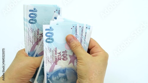 Turkish money 100 TL, female hand when calculating