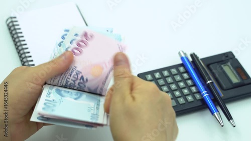 Turkish money 100 TL, female hand when calculating