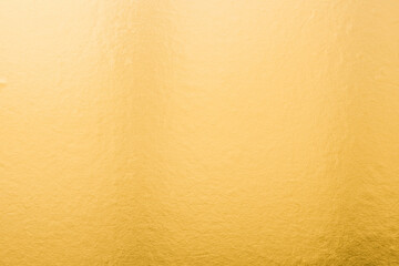 Gold background foil golden leaf metallic texture gradient light shiny reflective wrapping paper bright yellow solid color wallpaper for design decoration element backdrop