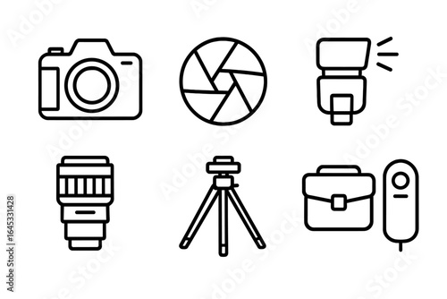 Photography equipment layout including camera, lenses, tripod, and accessories for a creative project at a workspace
