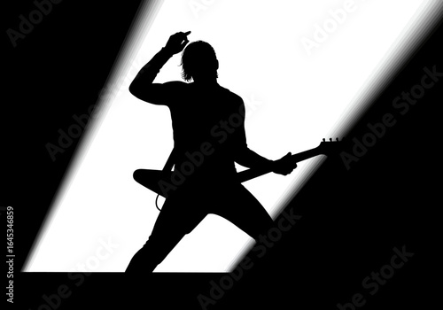 Silhouette of a Guitarist Performing on Stage with Spotlight