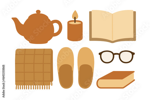 Cozy evening at home with tea, a candle, a book, and warm accessories during autumn or winter