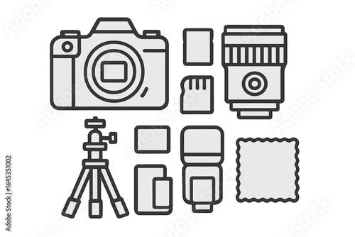 Photography equipment including camera, lens, tripod, and accessories arranged on a flat surface in a spacious studio