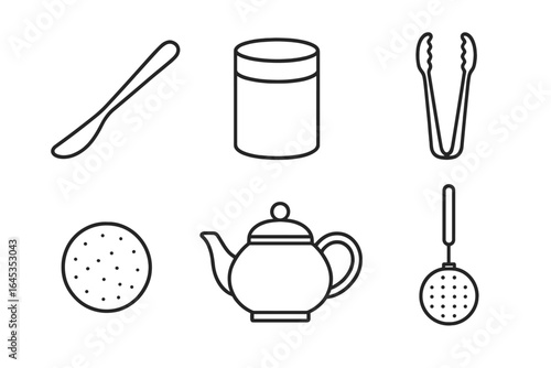 Kitchen utensils and tools arranged for a tea preparation setup in a cozy home environment
