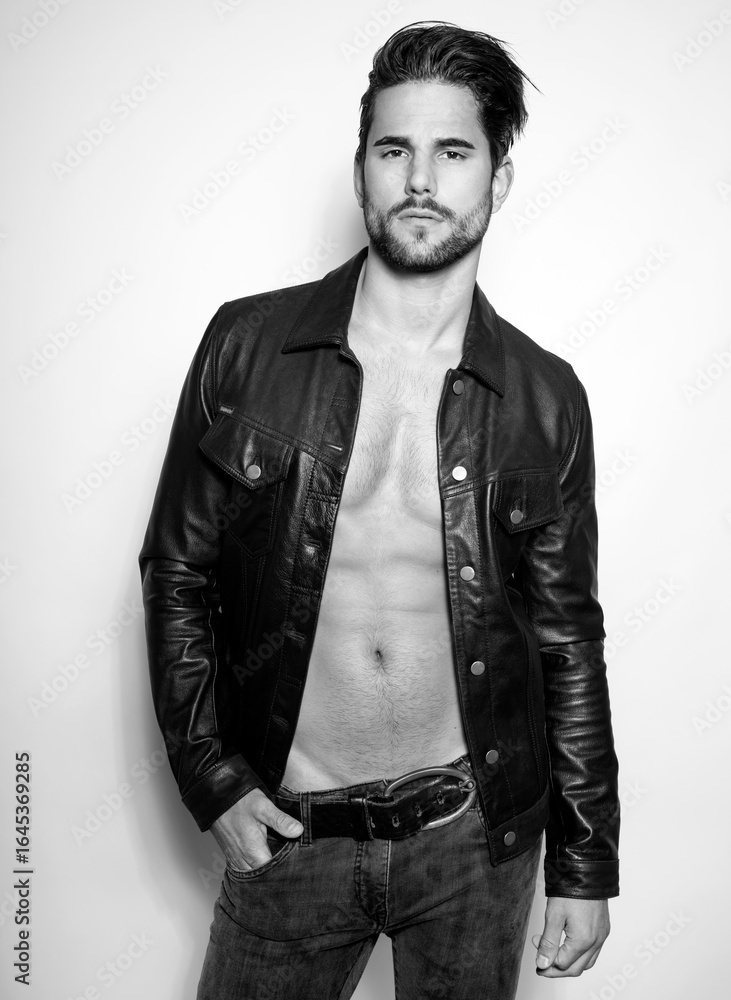Obraz premium Handsome young and alethic man with six pack in leather jacket